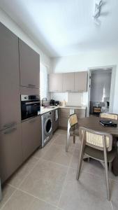 a kitchen with a table and a dining room at Beachfront Chic Penthouse in Rivière Noire +49 photos