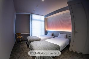 Postel nebo postele na pokoji v ubytování UNPLAN Village Hakuba