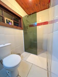 a bathroom with a toilet and a shower at Chalé Bangalo in Bocaina de Minas +9 photos