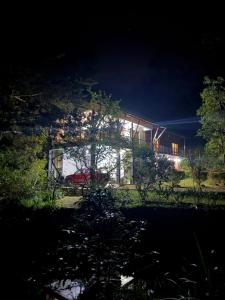 a house with a red car parked in front of it at Agarapathana Estate Holiday Bungalow in Hatton