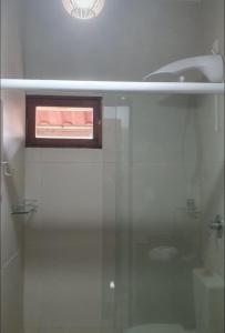 a bathroom with a glass shower with a sink at Suíte Sol do Gostoso in São Miguel do Gostoso +60 photos