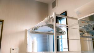 a glass shelf in a room with a mirror at Homey Inn in Kyoto +34 photos