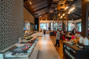 坤敬Avani Khon Kaen Hotel & Convention Centre的餐厅里的自助餐队伍周围站满了人