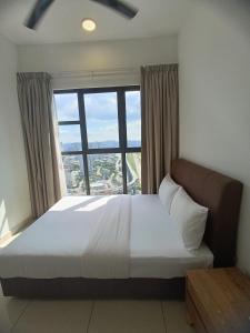 a bedroom with a large bed and a large window at Trion Residence Kuala Lumpur by Infinity in Kuala Lumpur