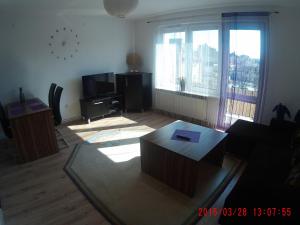 a living room with a couch and a table at Apartament Masovia in Mrągowo