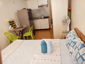 ダバオシティにあるSeawind Condo Tower 4, Studio Fully Furnishedのベッドルーム1室(ベッド1台付)、キッチン(ファン付) +6枚の写真