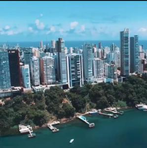 an aerial view of a city with boats in the water at Bahia Hotel Sol Vitoria Marina Flats in Salvador