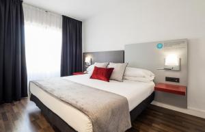 a hotel room with a bed and a television at Ilunion Suites Madrid in Madrid