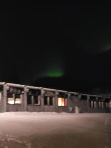 a building with a green light in the dark at Odd inge Sør-Reime as in Nesseby