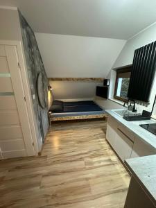 a room with a couch in the middle of a kitchen at Pokoje przy Kawiarence 2 in Rewa +18 photos