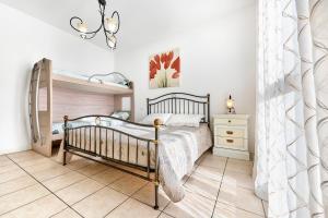 a bedroom with a bed and a dresser at Jesolo Flowers Beach House - Host Solution in Lido di Jesolo