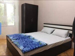 a bedroom with a bed with a black cabinet at Sweet home in Karawang