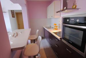 a small kitchen with a sink and a stove at Apartment Adriana in Makarska