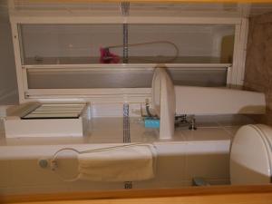 a kitchen counter with a sink and a drying rack at Pensión Aries II in Cuenca
