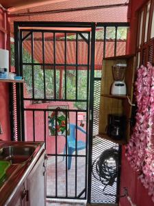 a kitchen with a glass door with a patio at Bowen apartamento in Quepos +5 photos