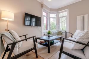 a living room with a couch and a table at Classy private spacious flat in North Berwick