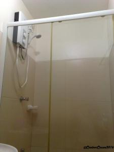 a shower with a glass door in a bathroom at Chateau Elysee in Manila
