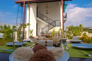 a table with plates of food on top of it at Villa Barbara - Private Pool Villa in Ahungalla in Ahungalla