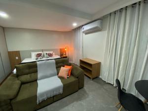 a living room with a couch and a bed at Manaus Hotéis Millenium - Flat 206 in Manaus +22 photos