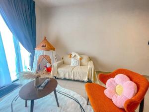 a room with a bed and a table and chairs at Desaru Apartment with Swimming pool By Ucome Homestay in Bandar Penawar +77 photos