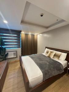 a bedroom with a large bed and a window at Exquisite Stays Private 2BR Rental in Manila +22 photos
