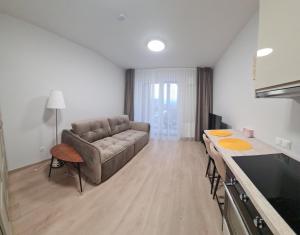 a living room with a couch and a table at Vita apartment in Vilnius