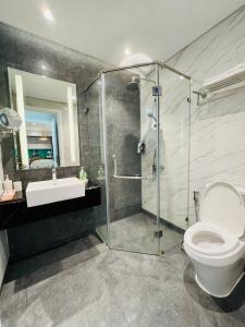 a bathroom with a shower and a toilet and a sink at CĂN HỘ ALTARA Hương vị Biển in Quy Nhon