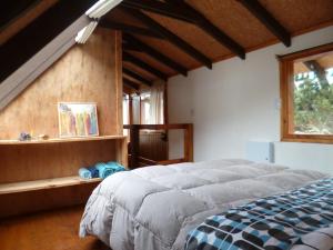 En eller flere senge i et værelse på Cabaña Entre Lagos y Montañas