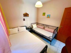 a room with two beds and a couch at Family house in Skála Foúrkas