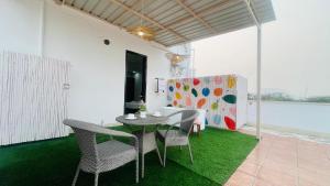 a dining room with a table and chairs on grass at BluO Penthouse - DLF CyberCity, BathTub - Terrace & Garden #staycation Gurgaon in Gurgaon