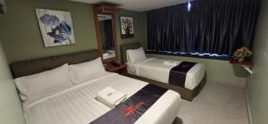 Postel nebo postele na pokoji v ubytování Enrich Hotel Semenyih by uBook