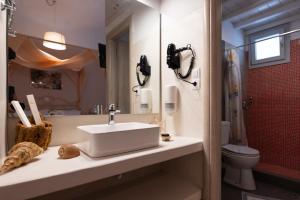 a bathroom with a sink and a toilet at Giasemi Rooms in Livadi Astypalaias +91 photos