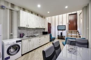 a kitchen with a washer and dryer in a room at Rustaveli Two Bedroom Apartment with 5 Star Location in Tbilisi City