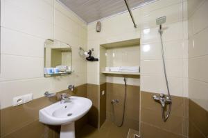 a bathroom with a sink and a shower at Rustaveli Two Bedroom Apartment with 5 Star Location in Tbilisi City +23 photos