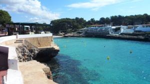 a large pool of blue water with people in it at Nachetes 1 in Cala Blanca