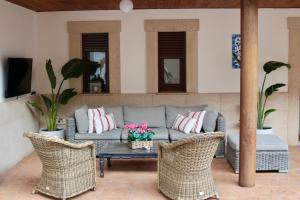 a living room with a couch and chairs and a table at CR Hanami House Boutique in Navaconcejo