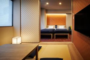 a bedroom with two beds in a room at Minn Nihonbashi in Tokyo