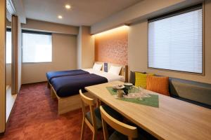 a hotel room with a bed and a dining table at Minn Nihonbashi in Tokyo