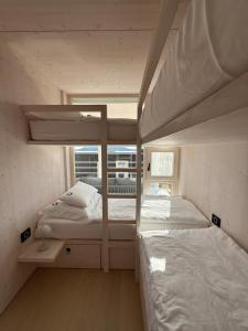 two bunk beds in a room with a window at Villa Aria Buqez Vita in Drage +45 photos