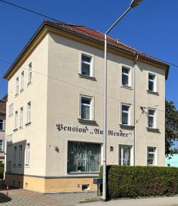 a building with a street light in front of it at Pension Am Renner in Dresden