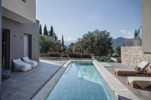 a swimming pool in the middle of a house at Nima Residences in Paleros