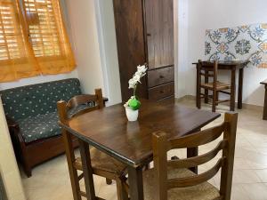 a dining room table with a vase of flowers on it at Norman City House in Palermo +28 photos