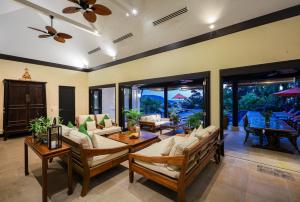 a living room with couches and a table at Katamanda villa Eden Large Villa near Kata Beach in Kata Beach