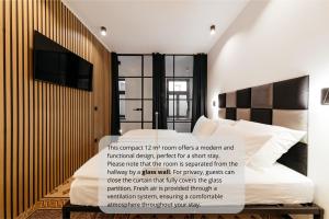 a bedroom with a bed with a sign on it at Main Square Rooms in Maribor +11 photos