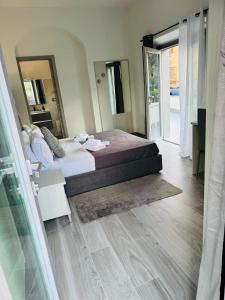 a bedroom with a bed and a large mirror at Affittacamere Mary's Rooms in San Teodoro