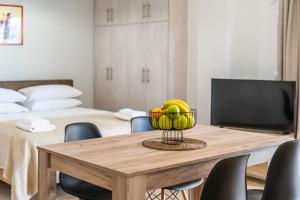 a dining room table with a bowl of fruit on it at NT Studio in Igoumenitsa