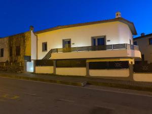 a white building with a balcony on the side of a street at Affittacamere Mary's Rooms in San Teodoro