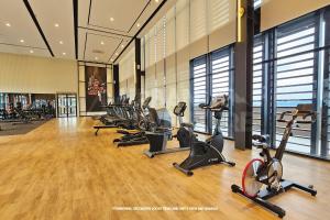a gym with a row of exercise bikes and treadmills at Mossaz Urban Adventure Suites KL in Petaling Jaya