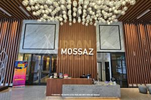 a lobby with a large chandelier in a museum at Mossaz Urban Adventure Suites KL in Petaling Jaya
