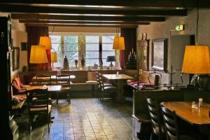 a living room with a table and chairs and a couch at Hotel zum alten Brauhaus in Dudeldorf
